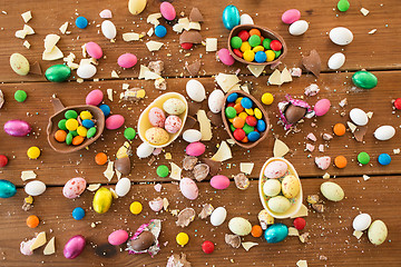 Image showing chocolate eggs and candy drops on wooden table