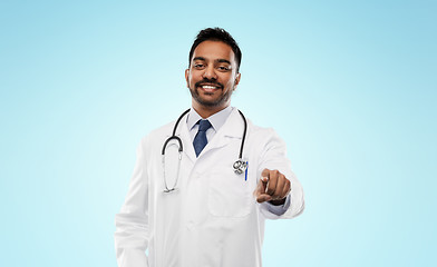 Image showing smiling indian male doctor pointing finger to you