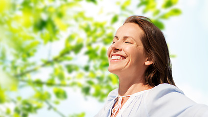 Image showing happy woman over green natural background