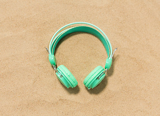 Image showing earphones on summer beach sand