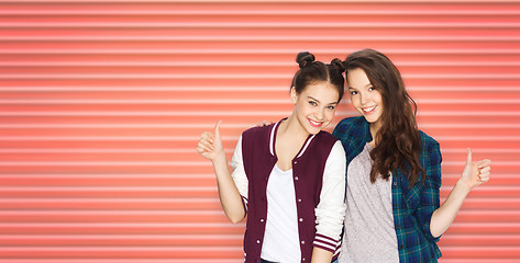 Image showing happy teenage girls or friends showing thumbs up