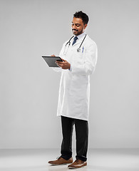 Image showing smiling indian male doctor with tablet computer