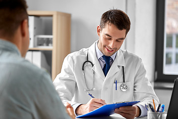 Image showing doctor with clipboard and male patient at hospital