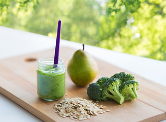 Image showing jar with puree or baby food on wooden board