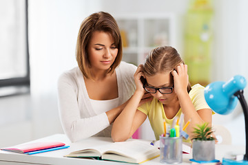 Image showing mother helping daughter with difficult homework