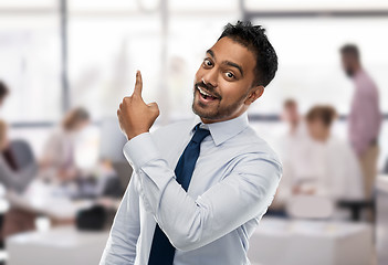 Image showing indian businessman pointing finger at something