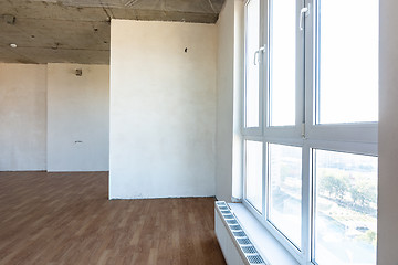 Image showing Large stained glass window and battery in the interior of an empty room of a new building