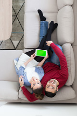 Image showing couple relaxing at  home with tablet computers