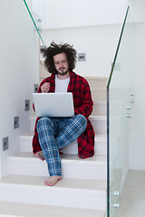 Image showing freelancer in bathrobe working from home