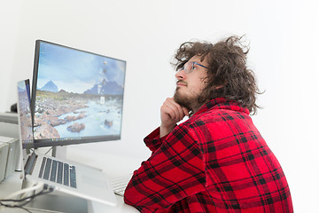 Image showing graphic designer in bathrobe working at home