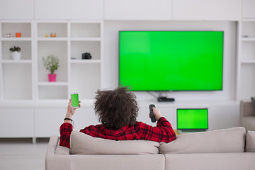 Image showing young man in bathrobe enjoying free time