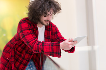 Image showing young freelancer using tablet computer