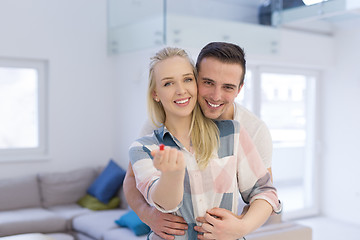 Image showing couple showing small red house in hands