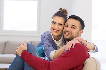 Image showing couple hugging and relaxing on sofa