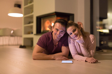 Image showing Young Couple using digital tablet on cold winter night