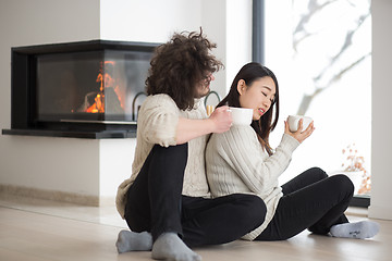 Image showing happy multiethnic couple  in front of fireplace