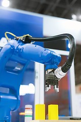 Image showing Automatic robot arm working in industrial environment