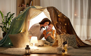 Image showing happy family with smartphone in kids tent at home