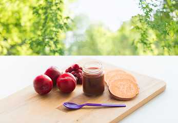 Image showing fruit puree or baby food in jar and feeding spoon