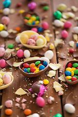 Image showing chocolate eggs and candy drops on wooden table