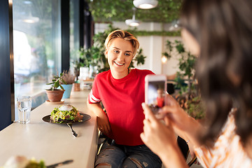 Image showing women having lunch and photographing at cafe