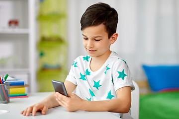 Image showing happy boy with smartphone at home