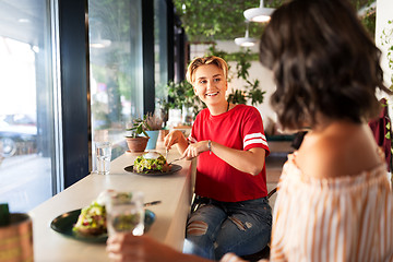 Image showing female friends eating at restaurant