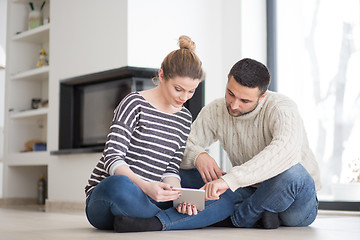 Image showing Young Couple using digital tablet on cold winter day