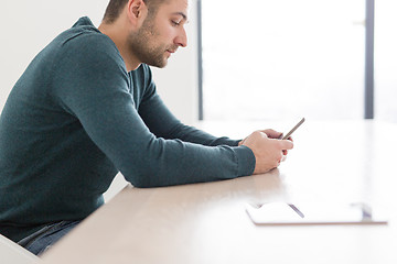 Image showing Young casual businessman using smartphone