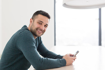 Image showing Young casual businessman using smartphone