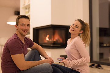 Image showing Young Couple using digital tablet on cold winter night