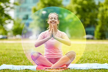 Image showing happy woman meditating in summer park