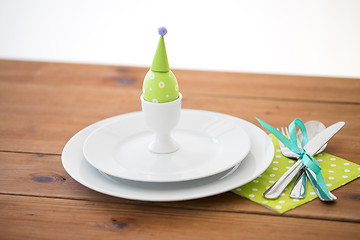 Image showing easter egg in cup holder, plates and cutlery