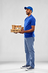 Image showing happy indian delivery man with food and drinks