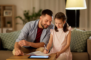 Image showing father and daughter doing homework together