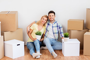 Image showing happy couple with boxes moving to new home