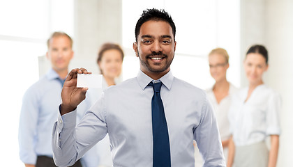 Image showing indian businessman with business card at office