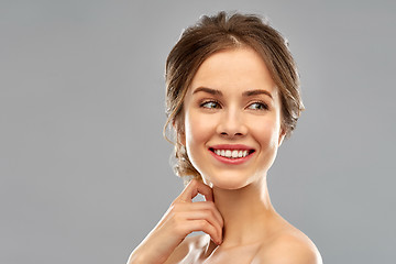 Image showing smiling young woman over grey background