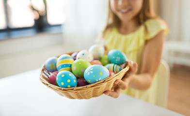 Image showing close up of girl with easter eggs in wicker basket