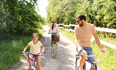 Image showing happy family with bicycles in summer park