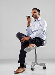 Image showing businessman using voice recorder on smartphone