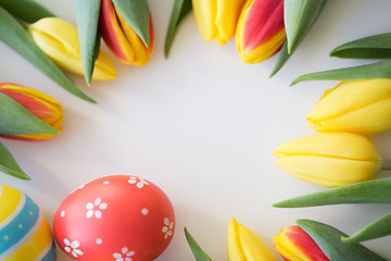 Image showing close up of colored easter eggs and tulip flowers