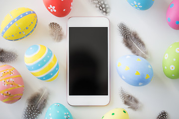 Image showing smartphone with easter eggs and feathers