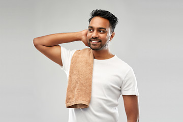 Image showing smiling indian man with towel over grey background