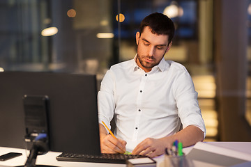 Image showing businessman with computer working at night office