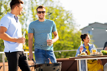 Image showing happy friends having bbq party on rooftop