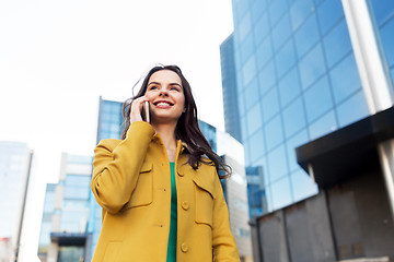 Image showing smiling young woman or girl calling on smartphone