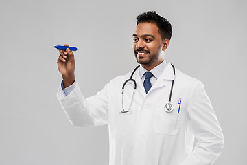 Image showing smiling indian male doctor with marker