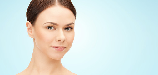 Image showing face of beautiful woman over blue background