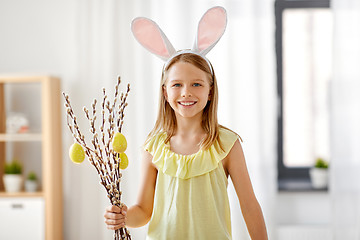 Image showing girl with willow decorated by easter eggs at home